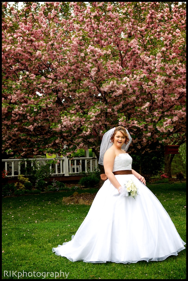 bride in front of pink blossoms