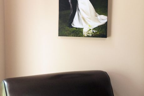 a 16x20 canvas hanging above a chair