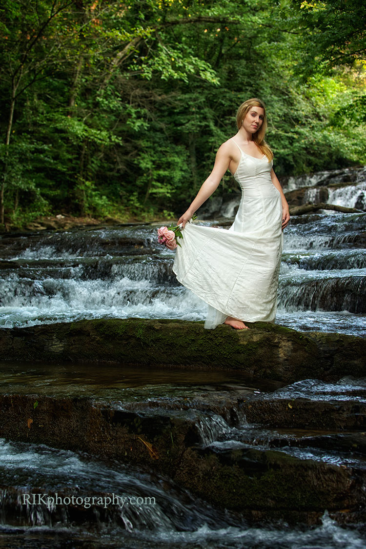 bride standing on a waterfall in the Smoky Mountains